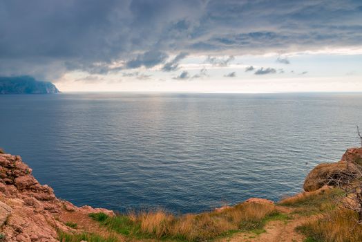 View from the cliffs to the sea and horizon to the dramatic sky