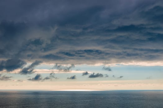 Beautiful blue clouds over the sea dramatic seascape