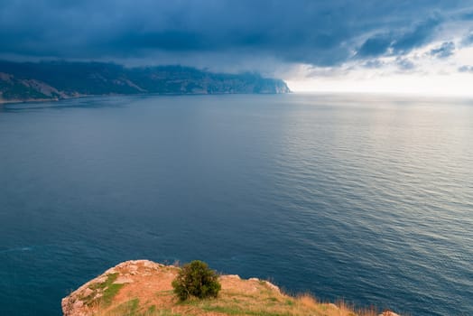 View of the sea, mountains and dramatic sky from the cliff, beautiful landscape