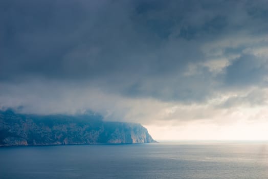 Clouds, sea and rocky shore beautiful scenic landscape with dramatic sky