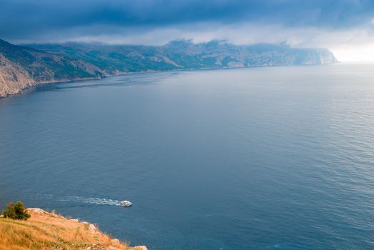 Landscape marine, a small boat goes to sea, weather before a storm