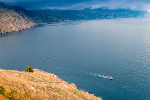 Top view of the bay, sea and mountains in front of the storm, dramatic sky