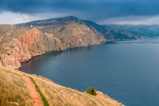 Black clouds over the mountains and the sea, beautiful dramatic seascape