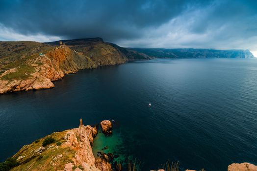 Blue sea, dark rain clouds dramatic landscape