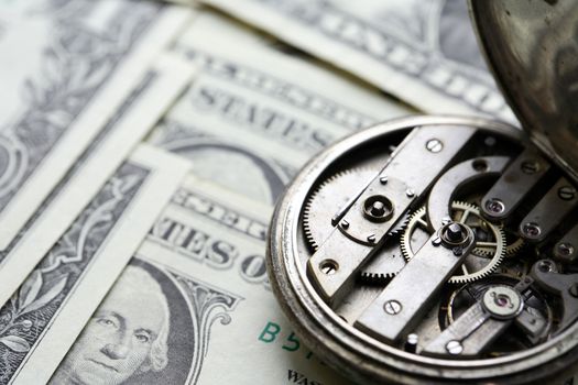 Bookkeeping concept. One dollar banknotes closeup as background and old watch