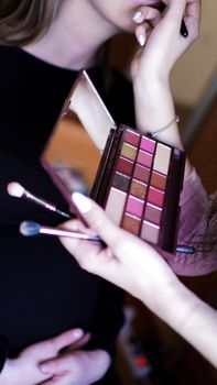 Hand use palette colorful and brush set makeup, beauty and fashion. Preparing make-up for the celebration, photo shoot