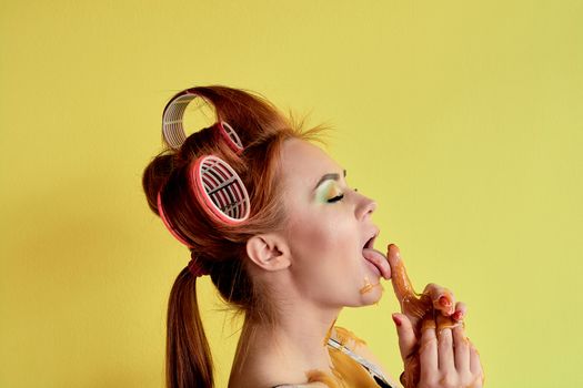 Young redhead woman with shugaring paste on her hands, face, body and chest. Young redhead woman with hair curlers. Advertising concept of shugaring paste. Skin care concept with copyspace.