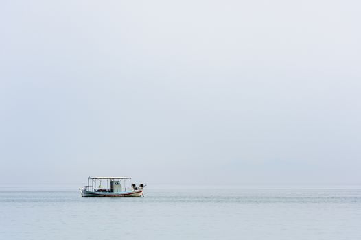Two small white fishing boat at sea surface
