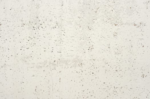 Natural concrete wall, with a porous texture. A close-up shot.