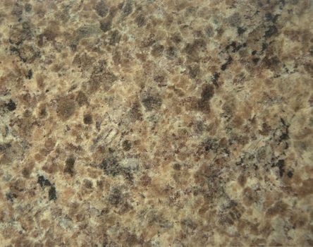 Light-brown granite with white and black impregnation. Close-up