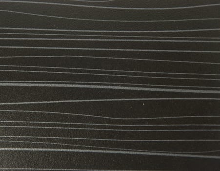 Horizontal silvery stripes on a black night background. Close-up