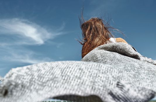 Happy woman dancing against the sky