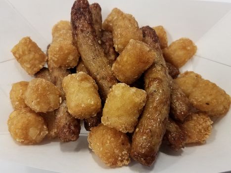 turkey sausage and tater tots potatoes in container on white surface