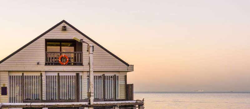 white beach house on the pier of Blankenberge, Belgium, Architecture of the Belgian coast at sunset