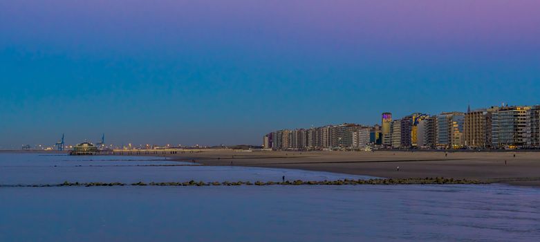 Blankenberge beach with view on the city and jetty, lighted architecture by night, popular coast of belgium