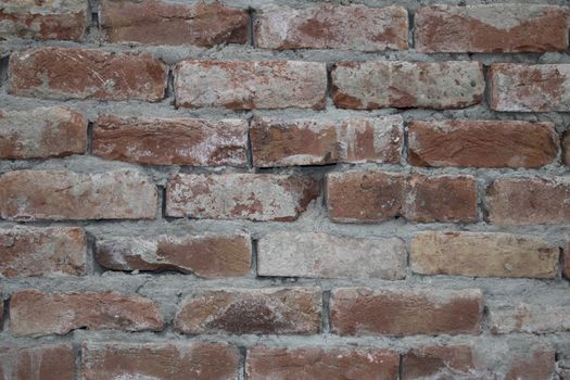 Destroyed brick wall, red texture grunge background