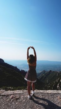 Young happy woman enjoying the magnifisent view of Montserrat Mountains