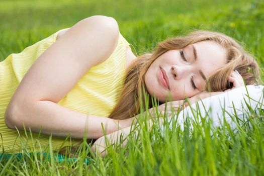 Rest and relaxation concept . Woman sleeping on pillow on grass background of nature