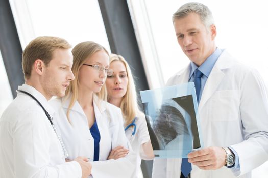 Medical colleagues discuss x-ray at clinical office