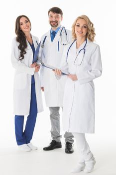 Successful team of medical doctors are looking at camera and smiling , studio isolated on white background