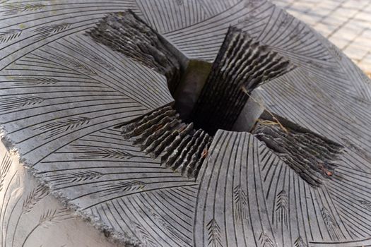 Stone monument to holocost. Hungry years symbol. Stone millstones mill.