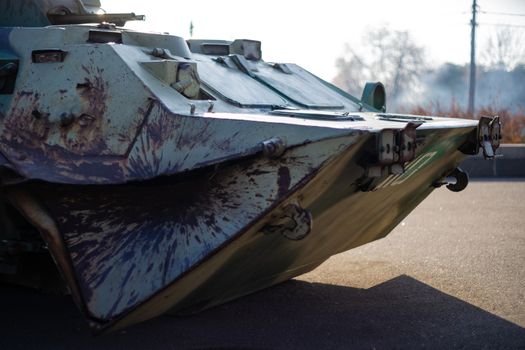 Damaged body of a military armored infantry. Outdoor military vehicles museum. Armor is damaged at the battlefield.