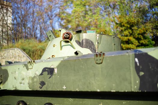 Damaged body of a military armored infantry. Part of  vehicle on photo. Outdoor military vehicles museum. Armor is damaged at the battlefield.