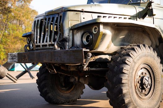 Camouflage military truck with rocket launcher. Outdoor military vehicles museum. Armor is damaged at the battlefield.