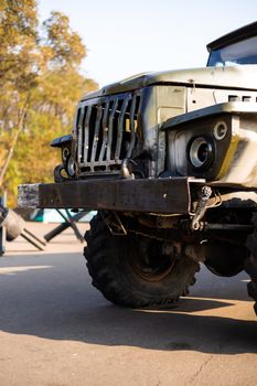 Camouflage military truck with rocket launcher. Outdoor military vehicles museum. Armor is damaged at the battlefield.