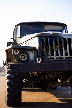 Camouflage military truck with rocket launcher. Outdoor military vehicles museum. Armor is damaged at the battlefield.