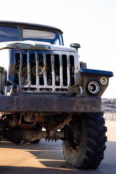 Camouflage military truck with rocket launcher. Outdoor military vehicles museum. Armor is damaged at the battlefield.