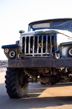 Camouflage military truck with rocket launcher. Outdoor military vehicles museum. Armor is damaged at the battlefield.