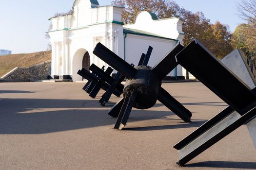 Black anti-hedgehogs on outdoor open air military vehicles museum. Close up view.