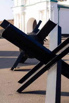 Black anti-hedgehogs on outdoor open air military vehicles museum. Close up view.