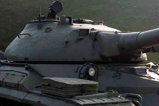 Parts of the hull of the old tank in the museum of military vehicles outdoor in the open air. Gun and truck parts closeup view.