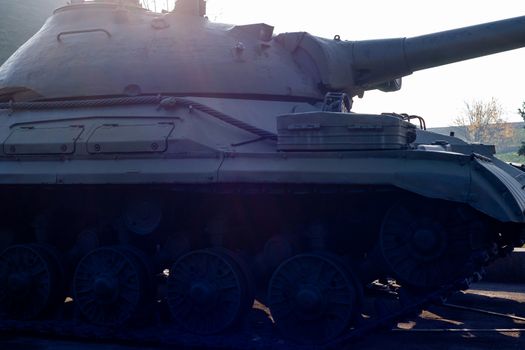 Parts of the hull of the old tank in the museum of military vehicles outdoor in the open air. Gun and truck parts closeup view.