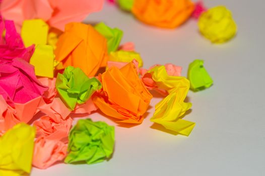 Bright crumpled multi-colored stickers on the office white board.