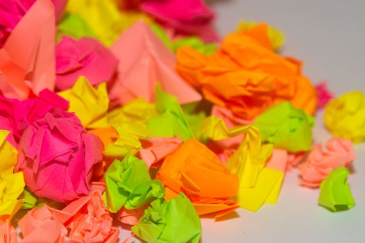 Bright crumpled multi-colored stickers on the office white board.