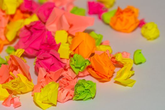 Bright crumpled multi-colored stickers on the office white board.