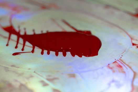 Hue red acrylic paint on glare table. Palette on table. Artist life.