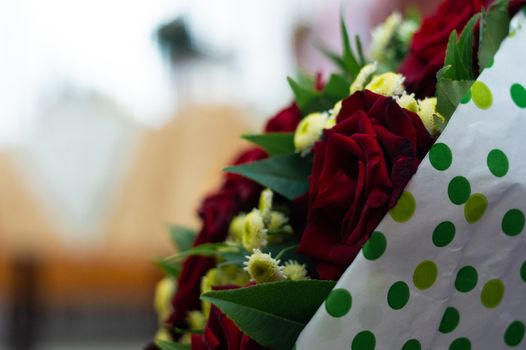 Bouquet of roses in bride hands. Weddind details in closeup view. Solemn event.