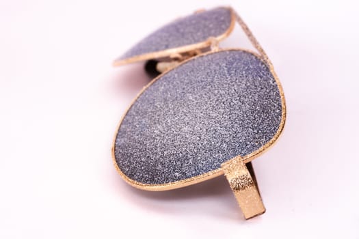 Sunglasses with artificial snow on white background close-up view.