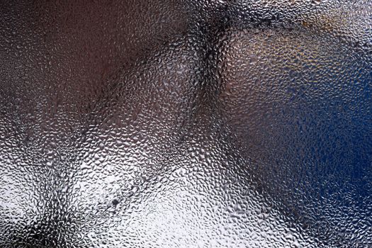 Water drops on glass window close up with blurred background. Drops in macro. Condensate on window closeup. Wet air.