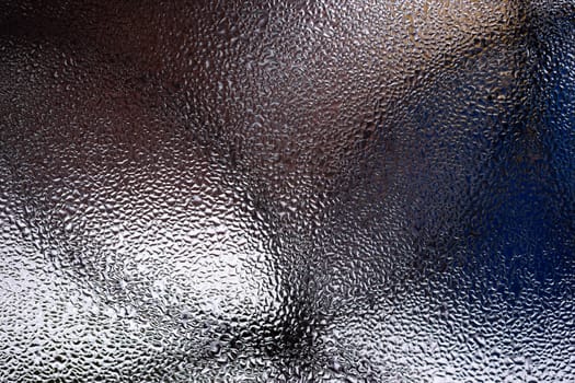 Water drops on glass window close up with blurred background. Drops in macro. Condensate on window closeup. Wet air.