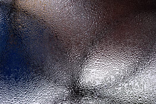 Water drops on glass window close up with blurred background. Drops in macro. Condensate on window closeup. Wet air.