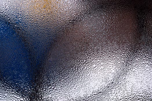 Water drops on glass window close up with blurred background. Drops in macro. Condensate on window closeup. Wet air.