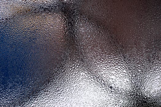 Water drops on glass window close up with blurred background. Drops in macro. Condensate on window closeup. Wet air.