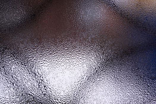 Water drops on glass window close up with blurred background. Drops in macro. Condensate on window closeup. Wet air.
