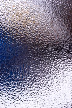 Water drops on glass window close up with blurred background. Drops in macro. Condensate on window closeup. Wet air.