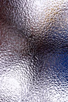 Water drops on glass window close up with blurred background. Drops in macro. Condensate on window closeup. Wet air.